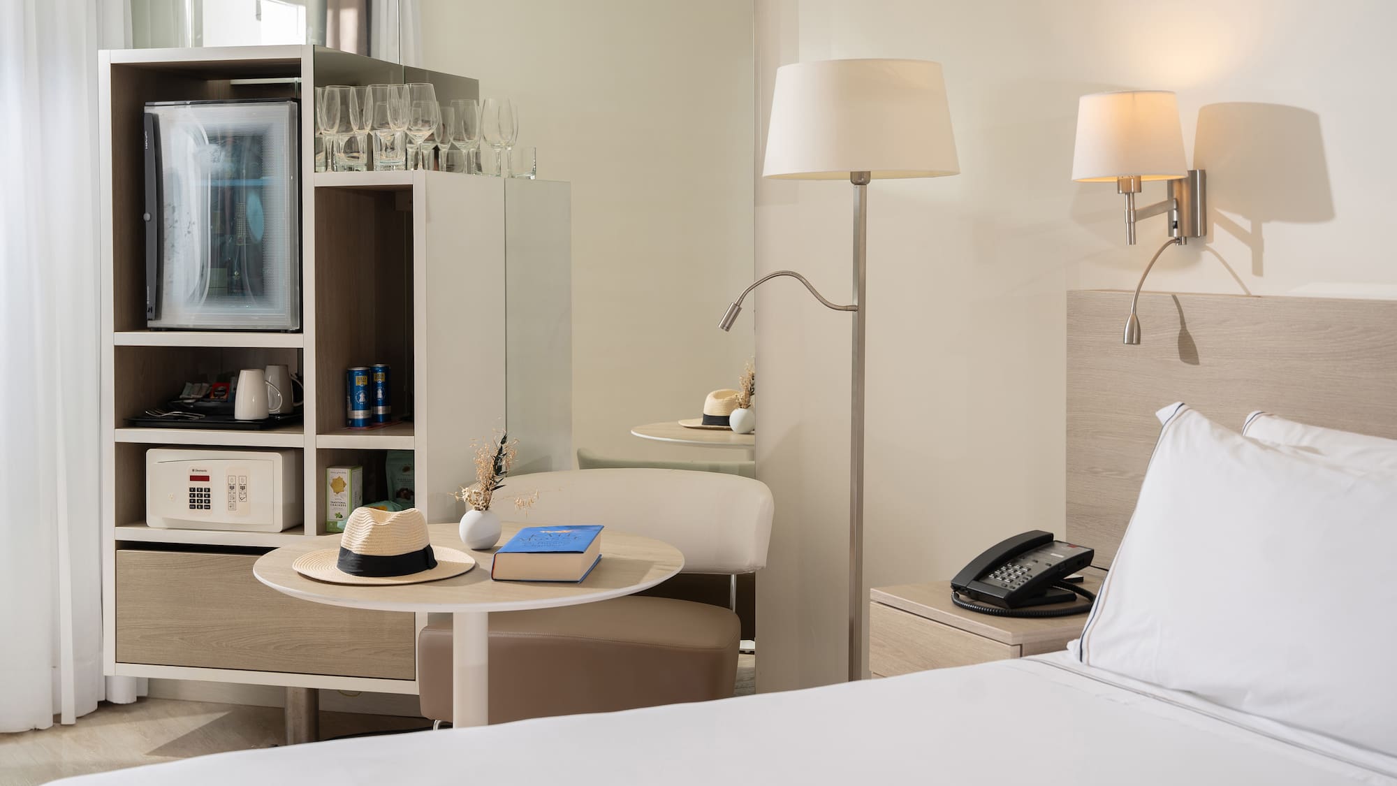 a room with a bed and a table and a television