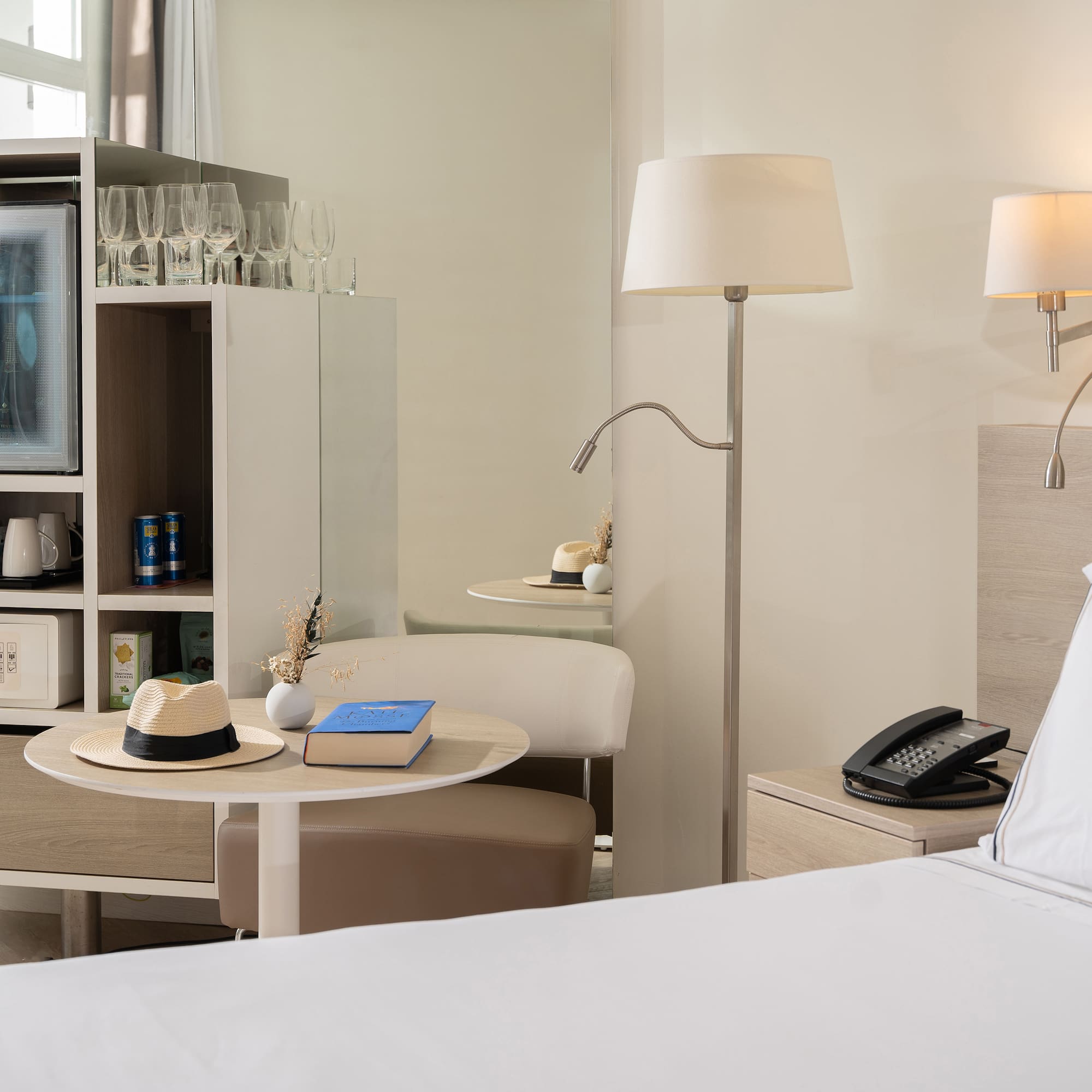 a room with a bed and a table and a television