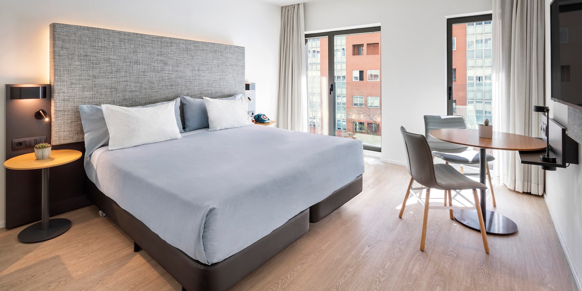 a bedroom with a table and chairs