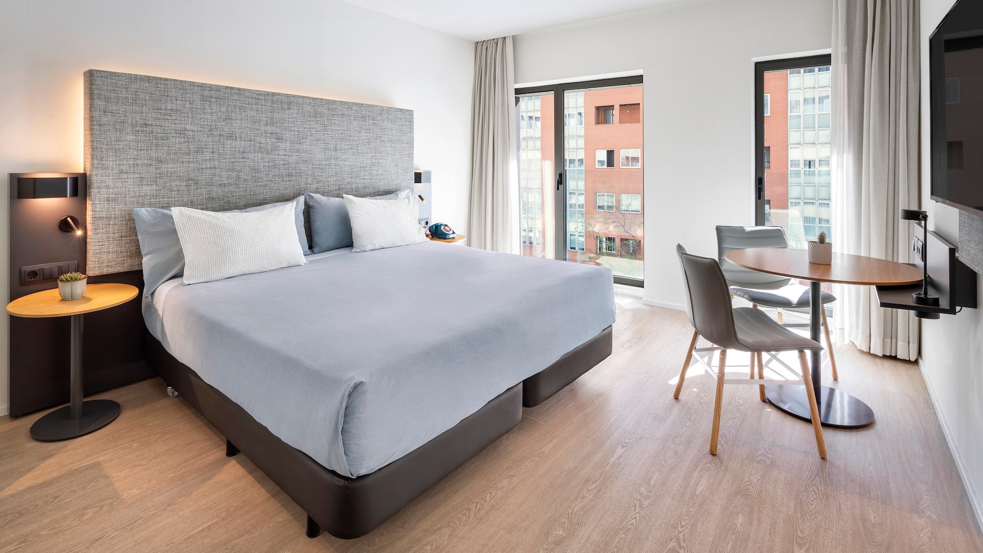 a bedroom with a table and chairs