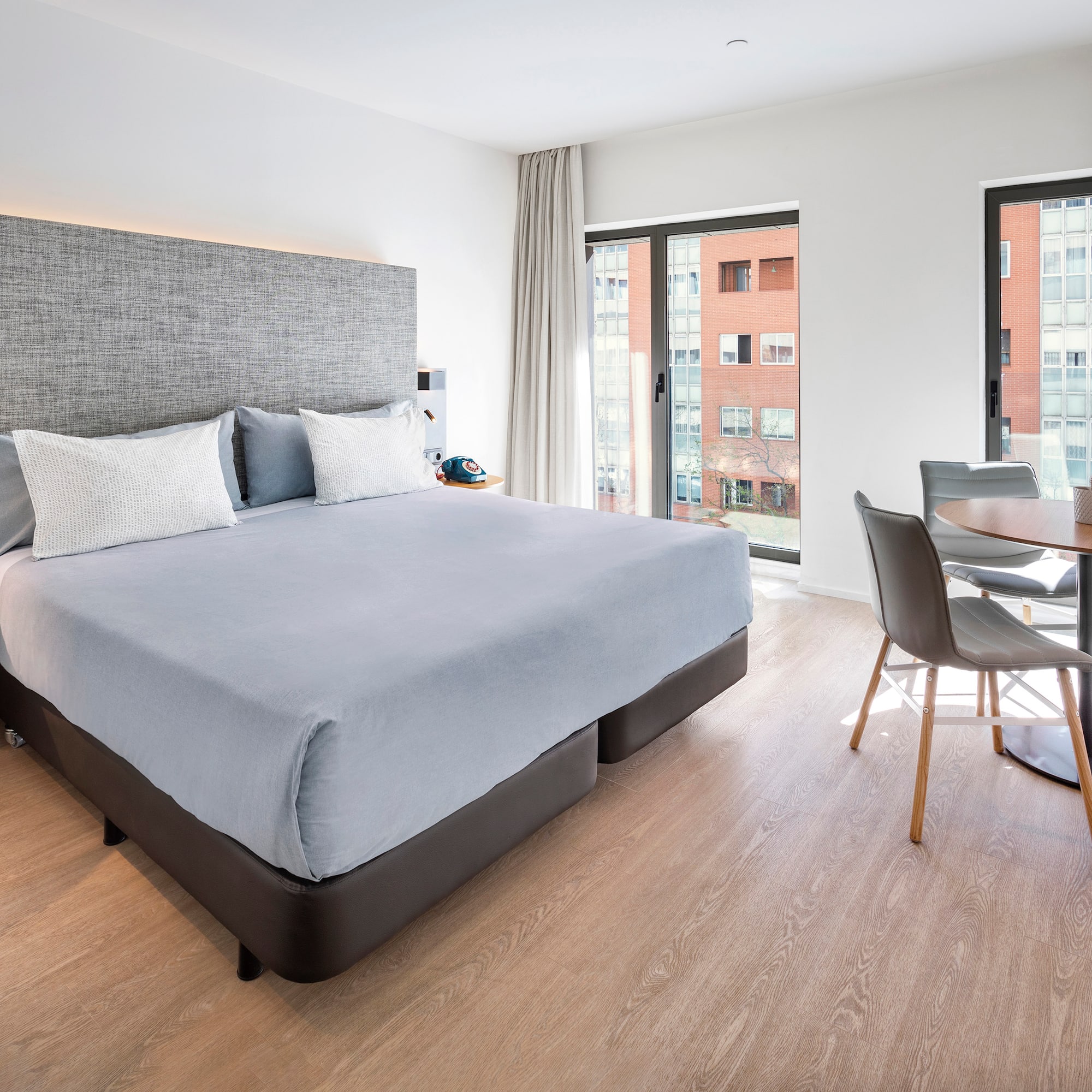 a bedroom with a table and chairs