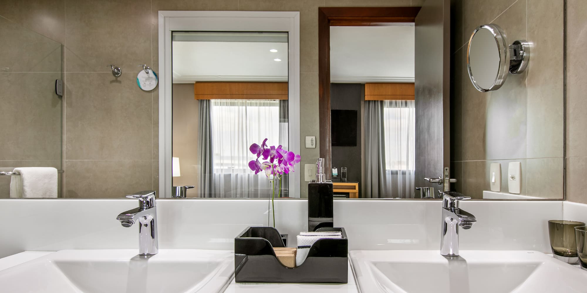 a bathroom with two sinks and a mirror