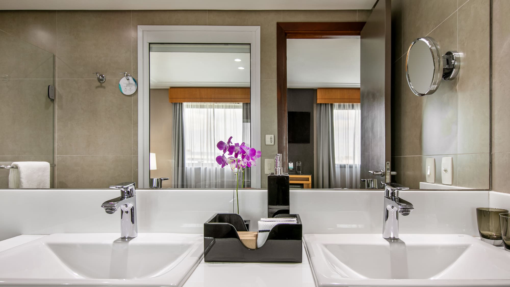 a bathroom with two sinks and a mirror