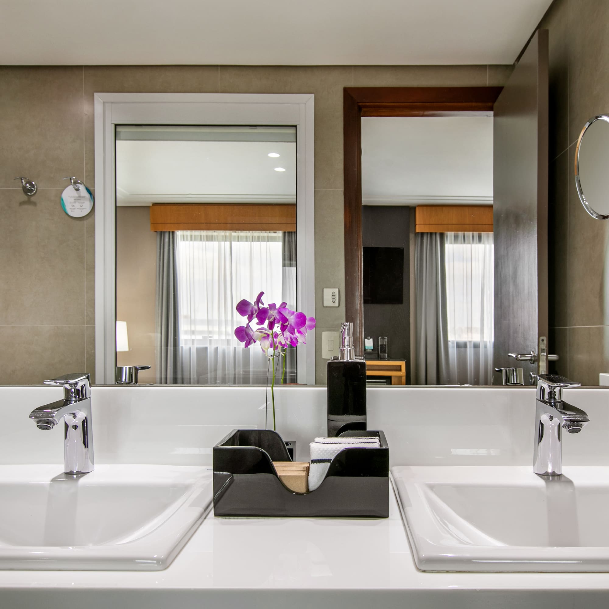 a bathroom with two sinks and a mirror