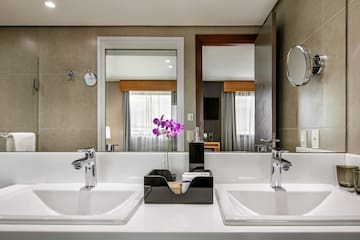 a bathroom with two sinks and a mirror