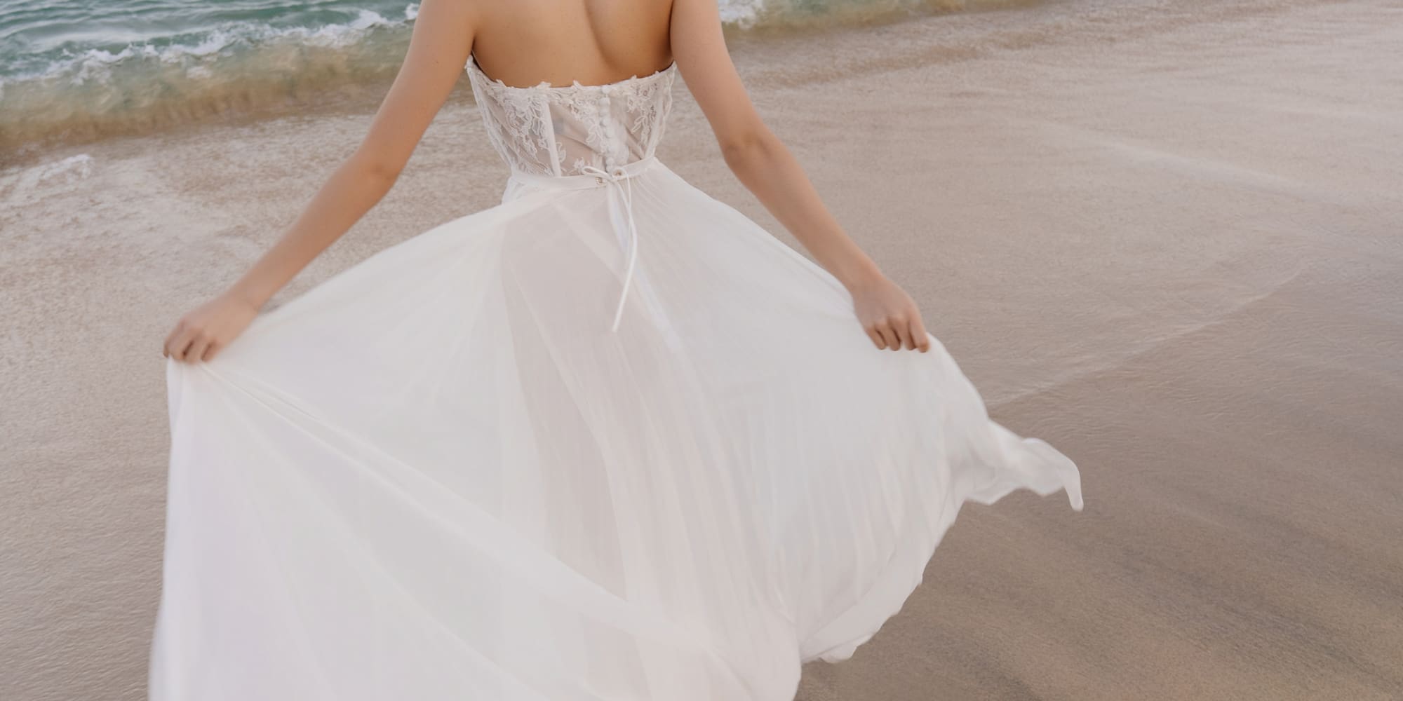 a woman in a white dress on a beach