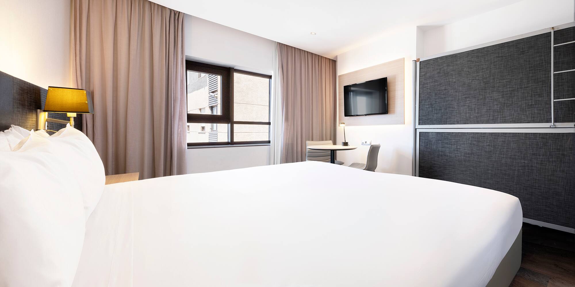 a room with a bed and a tv