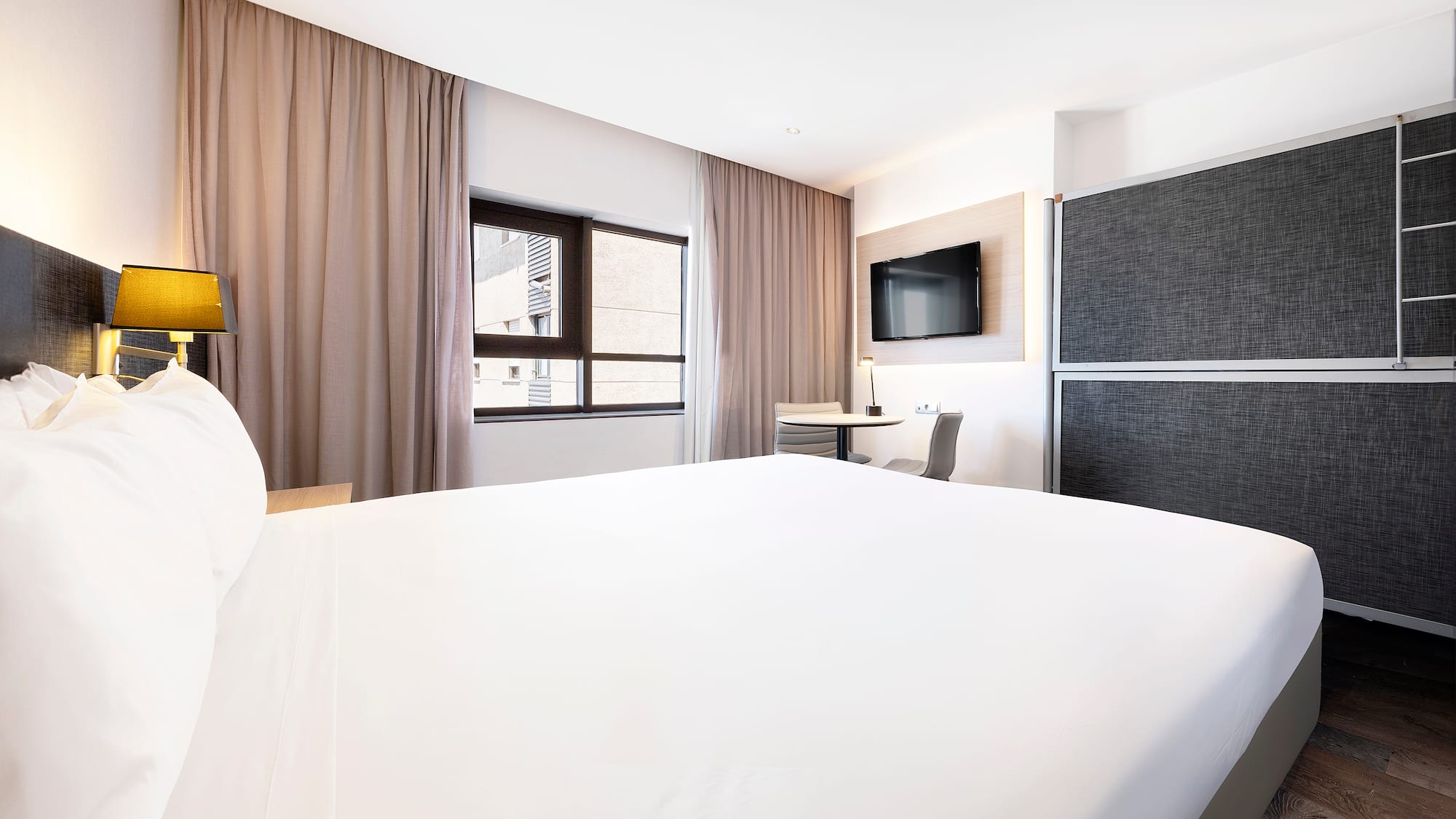 a room with a bed and a tv