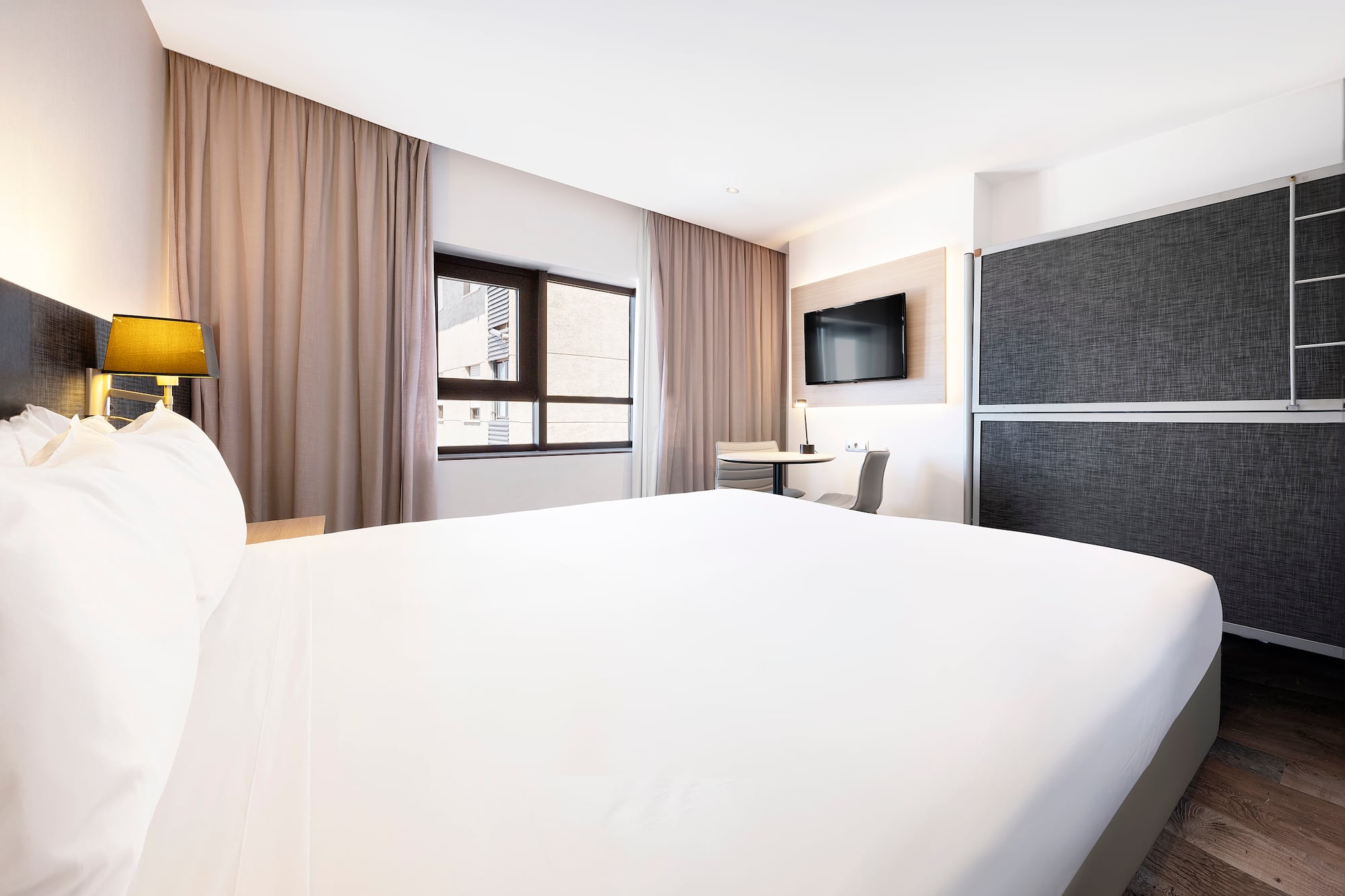 a room with a bed and a tv