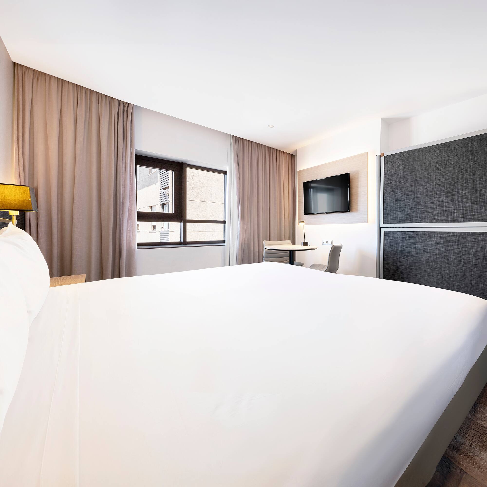 a room with a bed and a tv