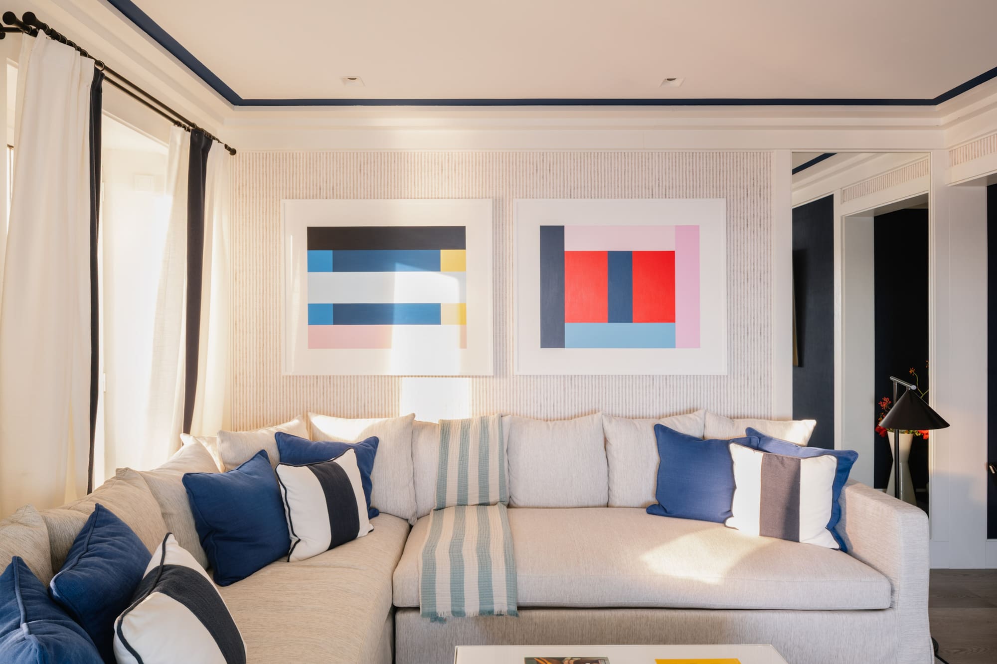 a couch with pillows and a coffee table in a room