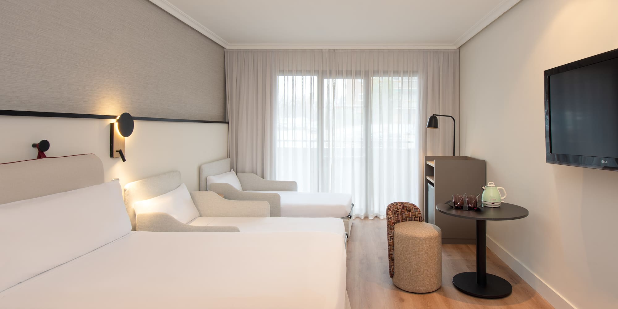 a room with two beds and a table