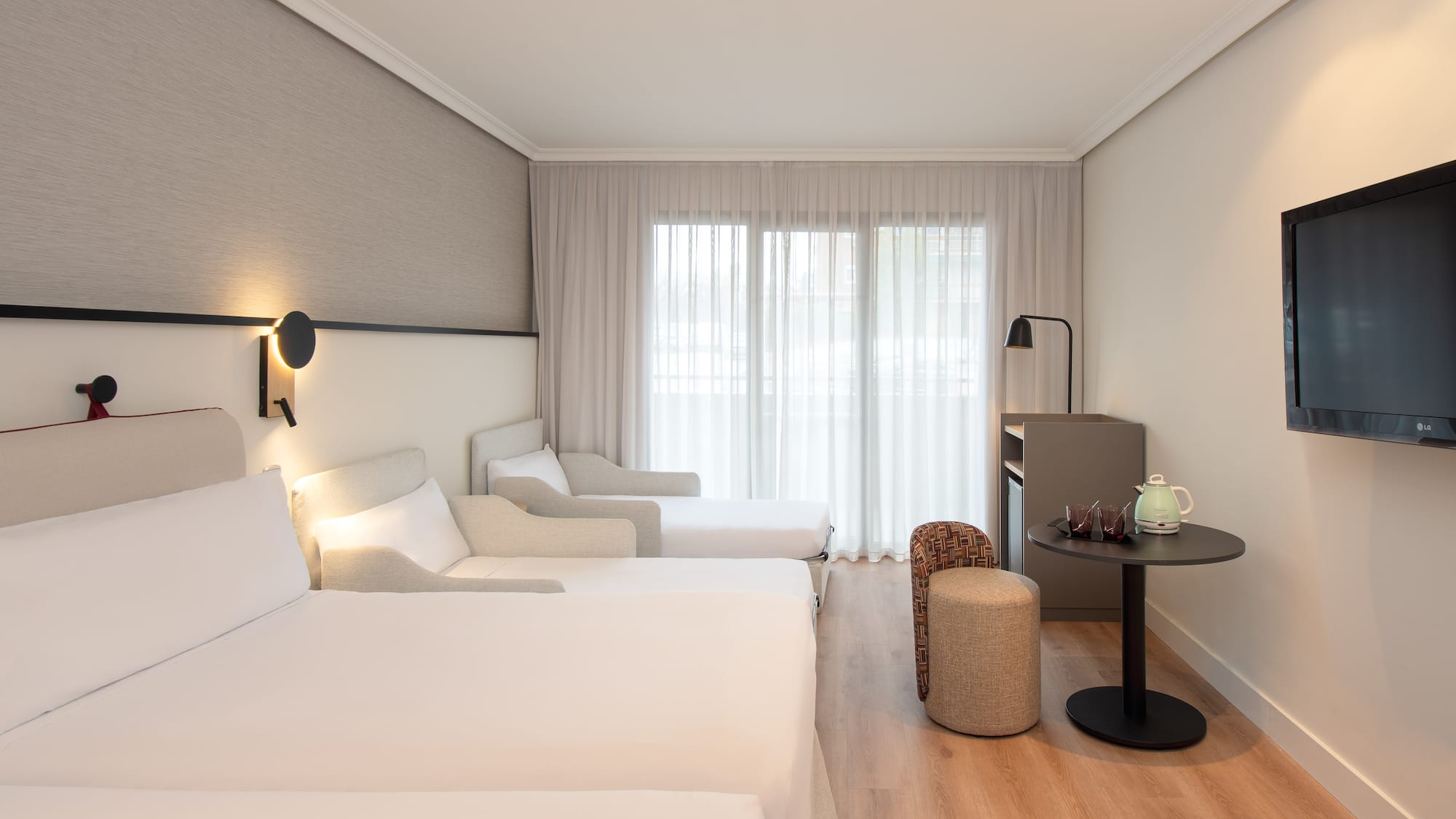 a room with two beds and a table