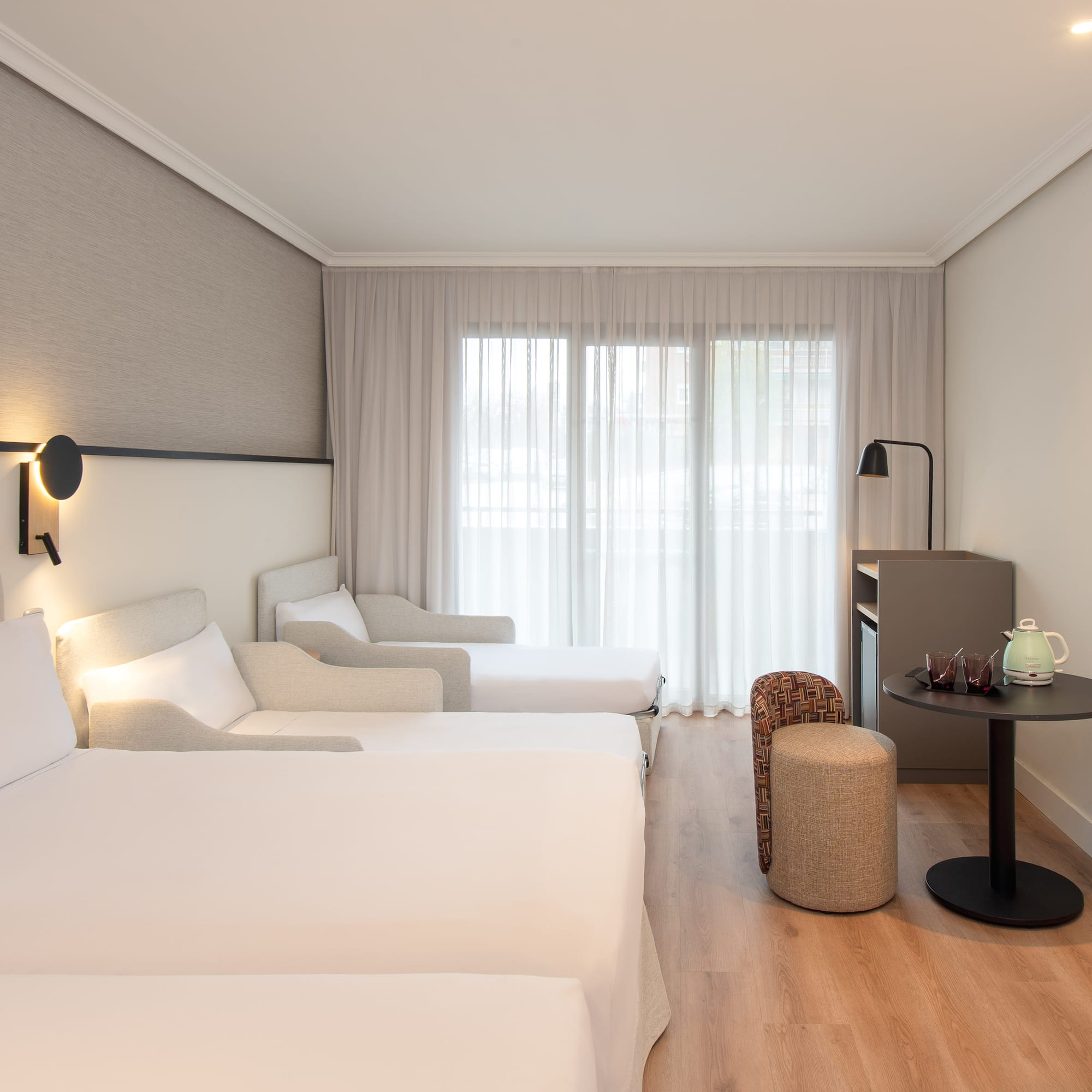 a room with two beds and a table