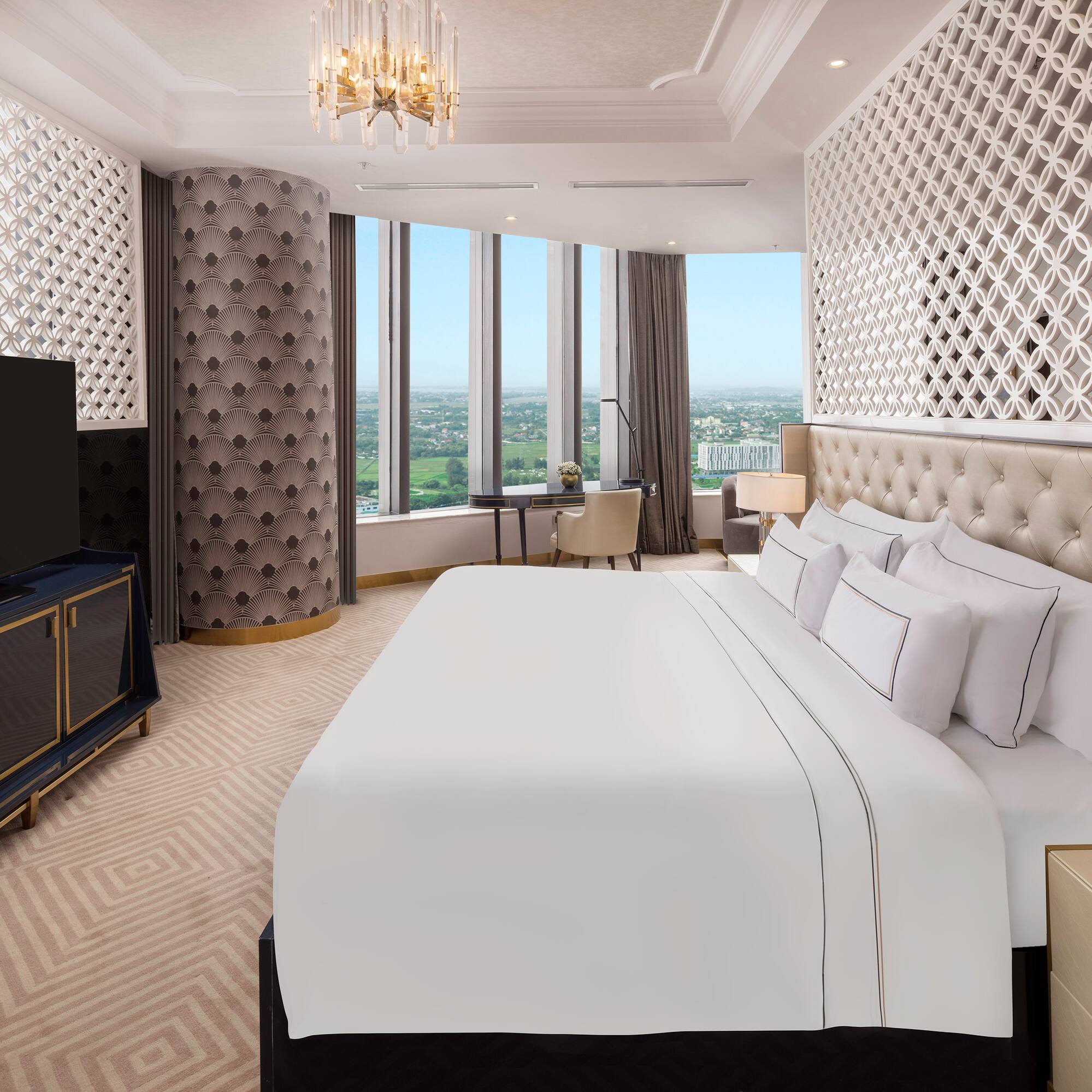 a room with a large bed and a television