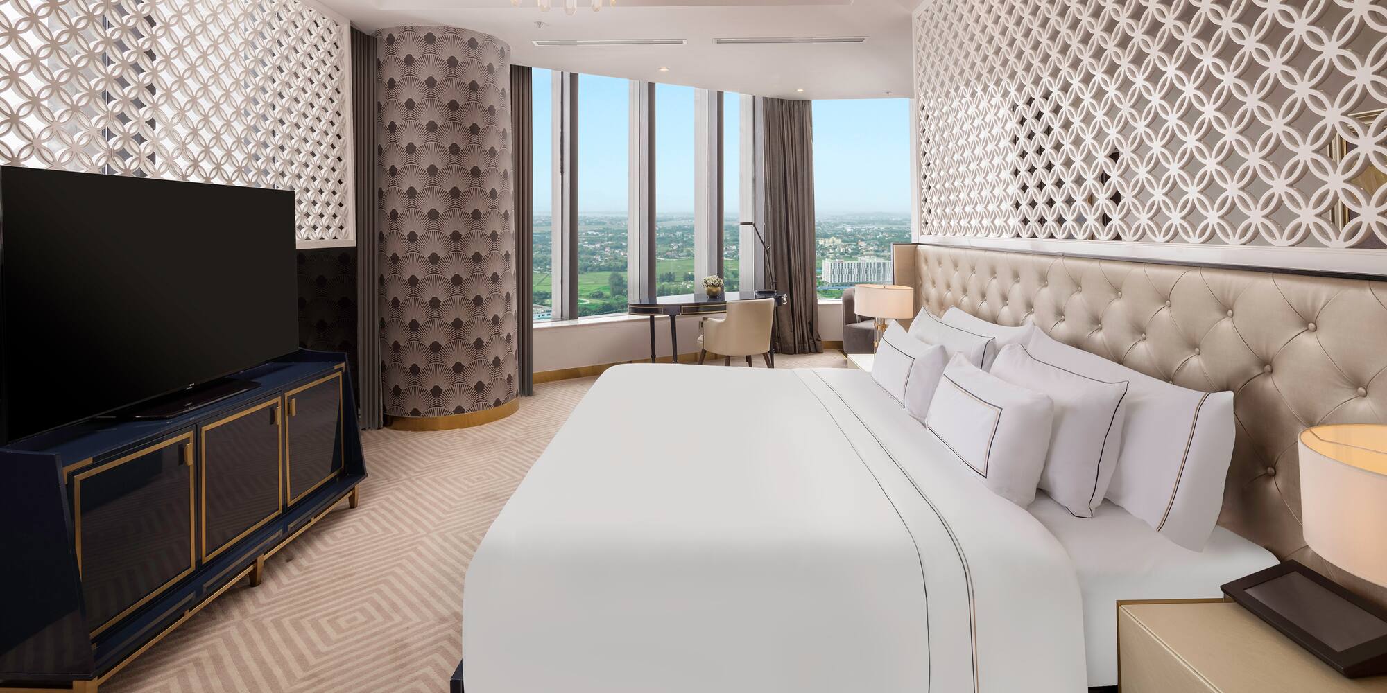 a room with a large bed and a television