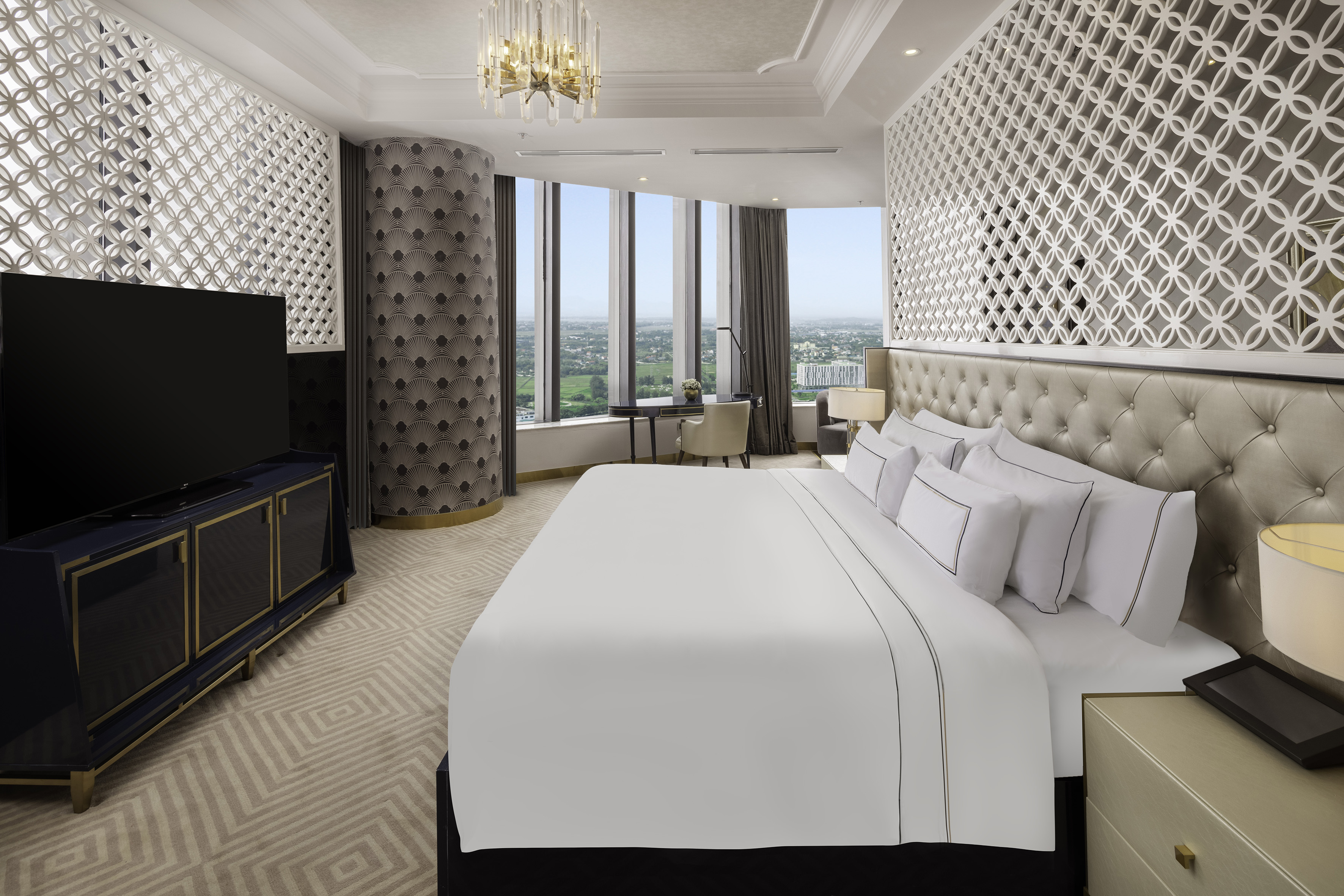 a room with a large bed and a television