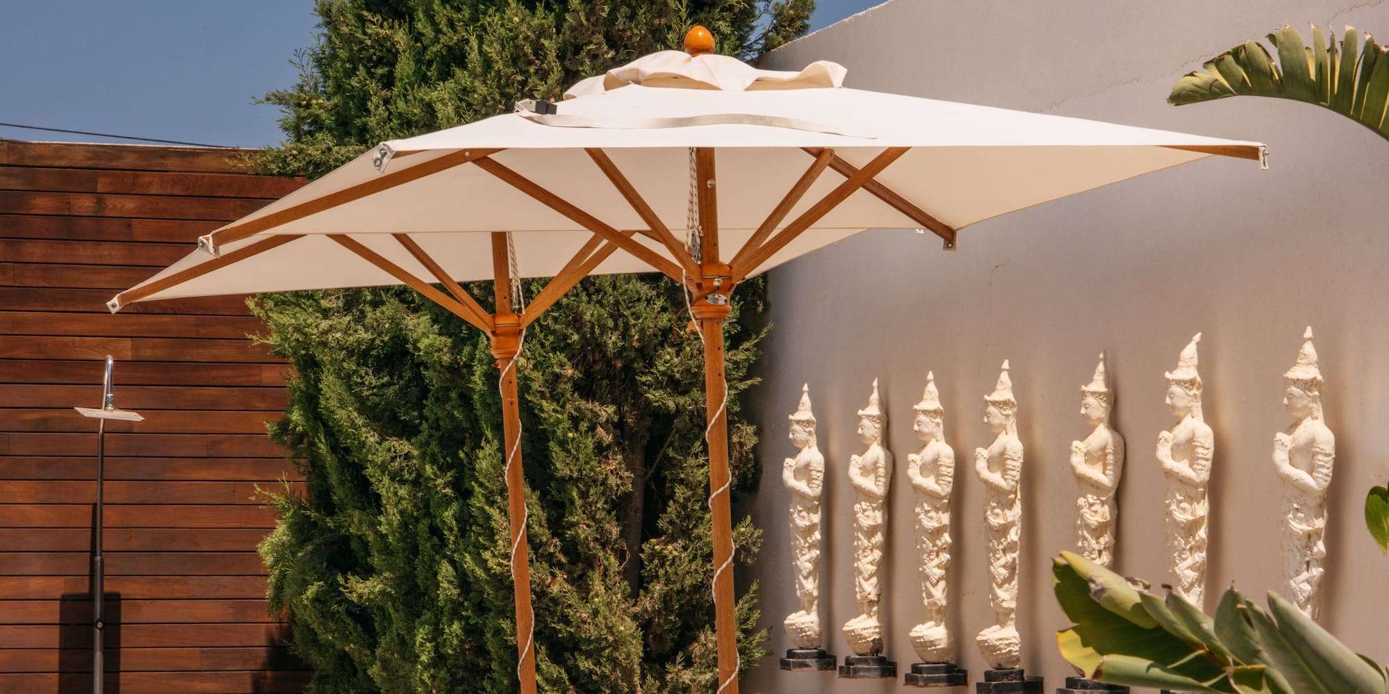 a group of lounge chairs with umbrellas