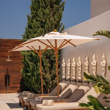 a group of lounge chairs with umbrellas