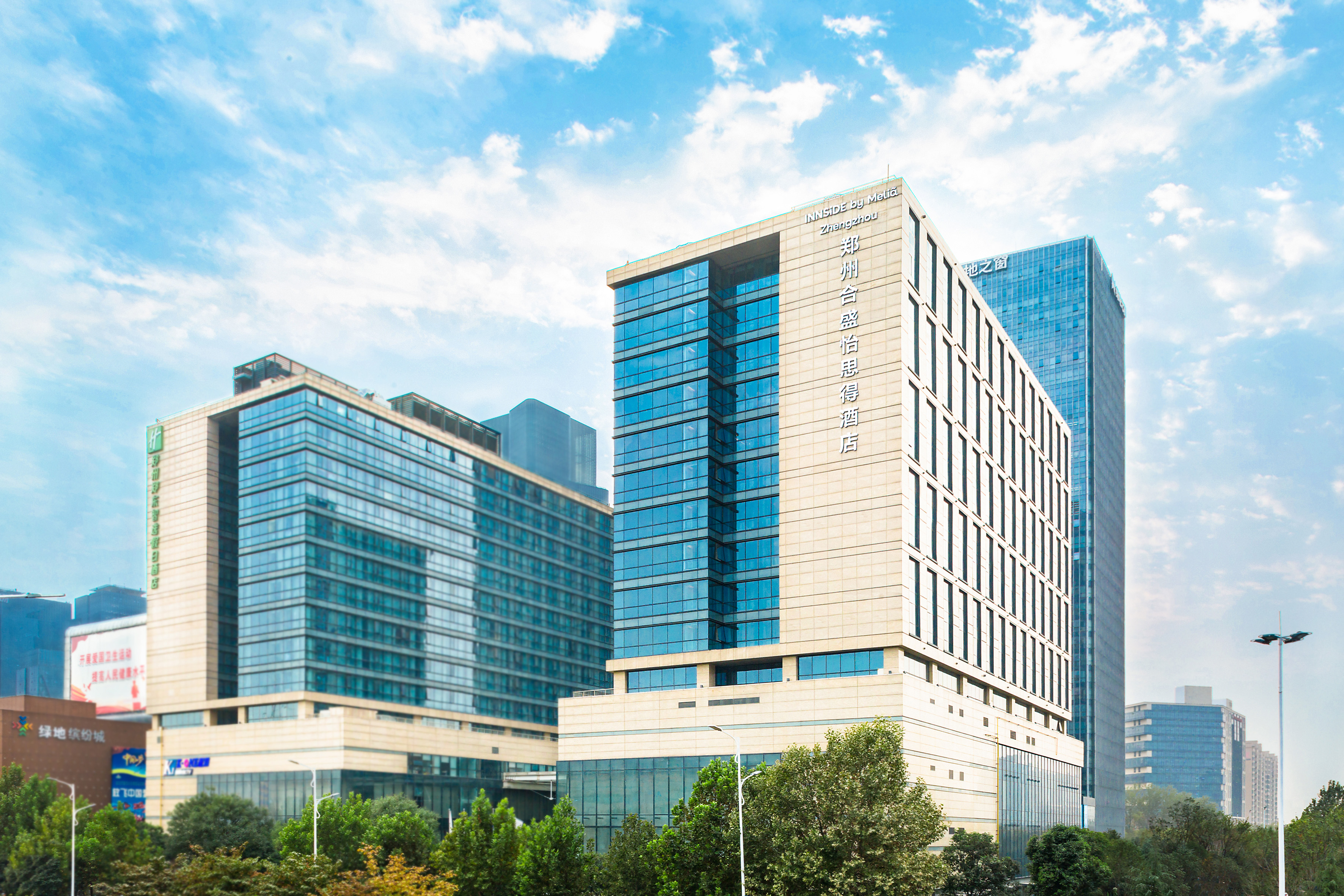 Modern INNSIDE by Melia Zhengzhou hotel and glass-fronted buildings.
