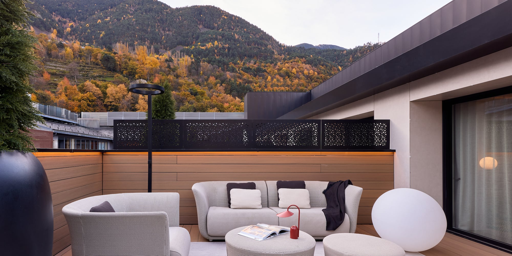 a patio with a view of mountains and trees