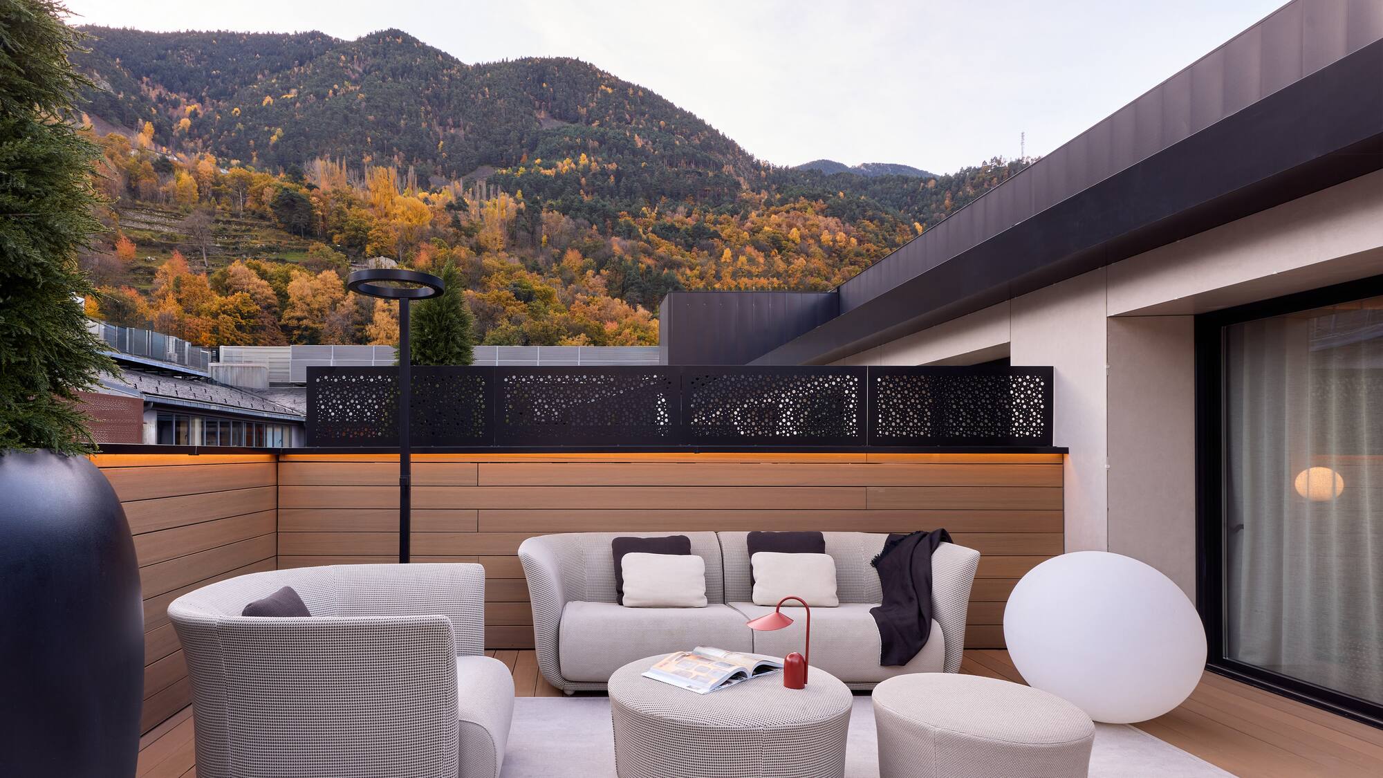a patio with a view of mountains and trees