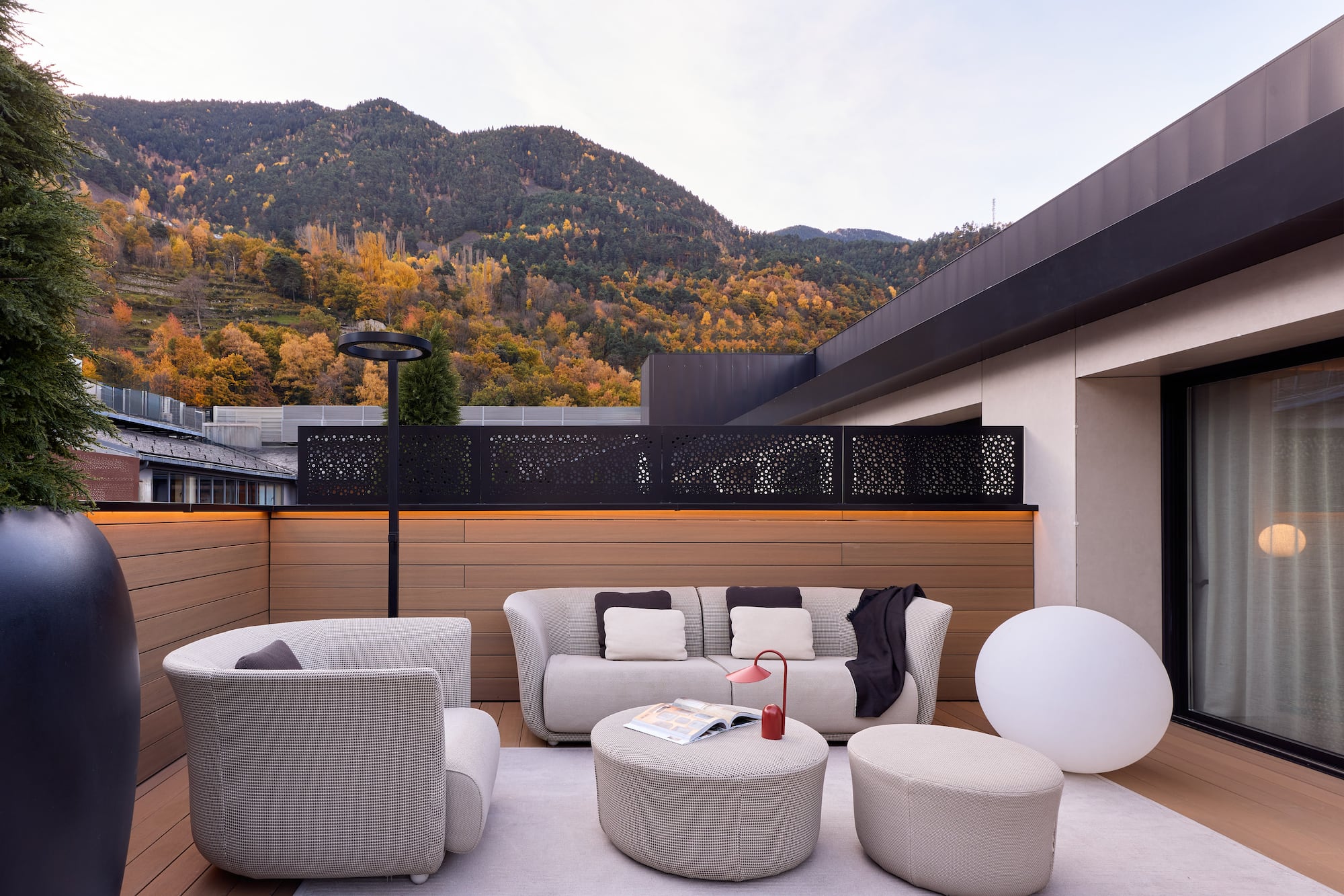 a patio with a view of mountains and trees