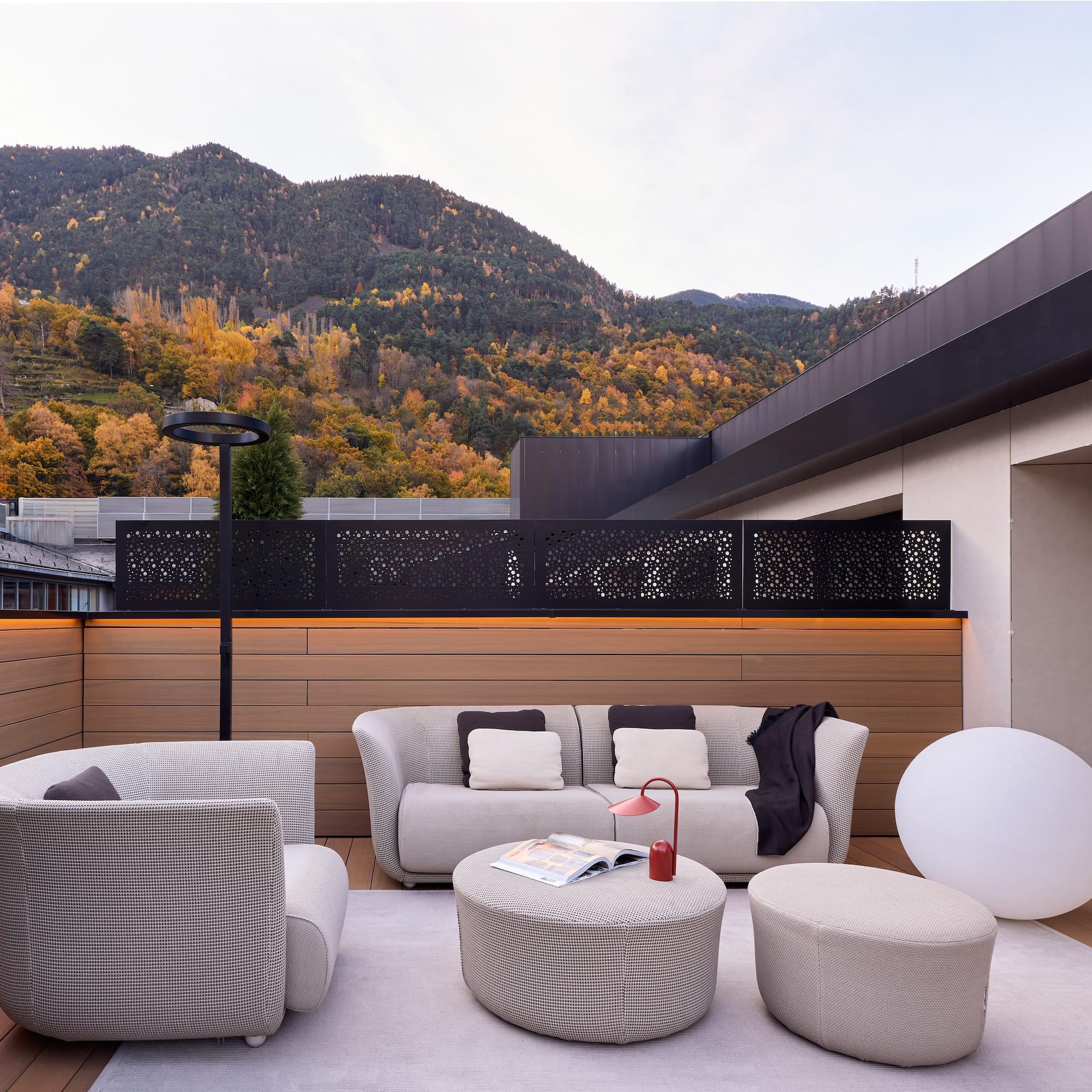 a patio with a view of mountains and trees