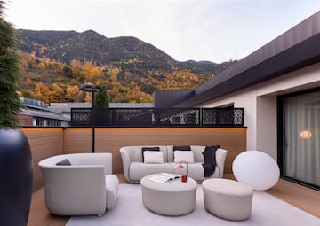 a patio with a view of mountains and trees