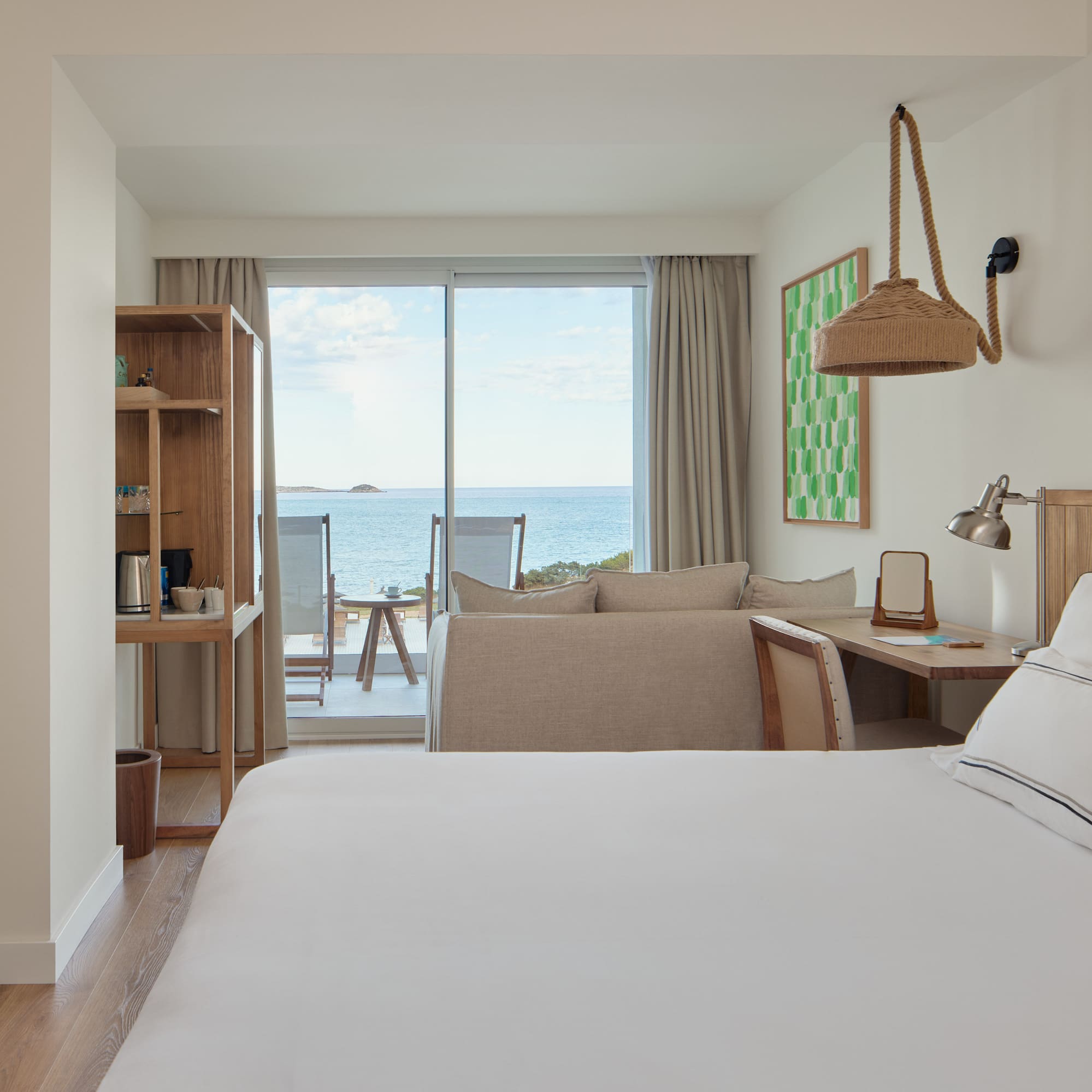 a room with a bed and a table and chairs