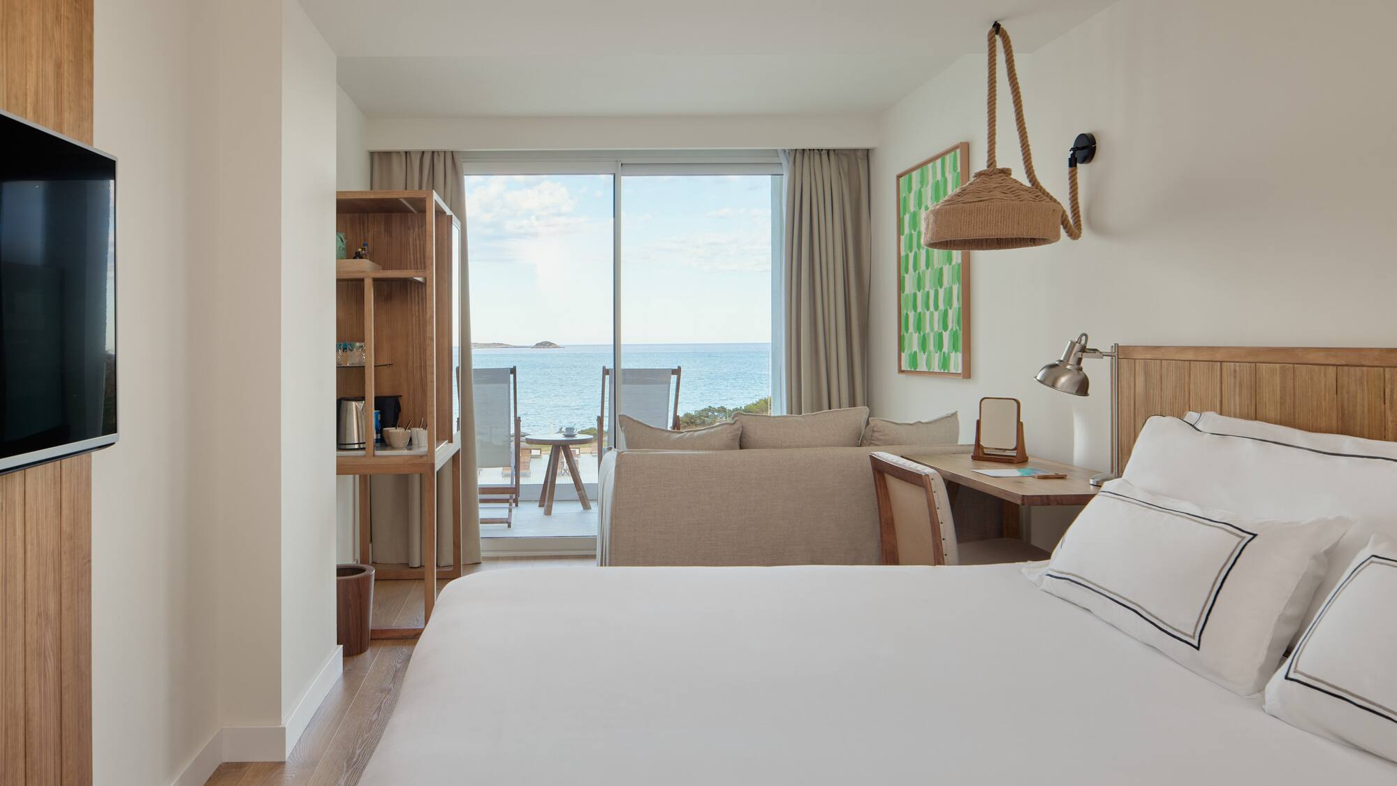 a room with a bed and a table and chairs