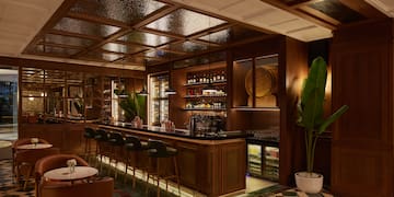 a bar with a bar stools and chairs