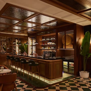 a bar with a bar stools and chairs