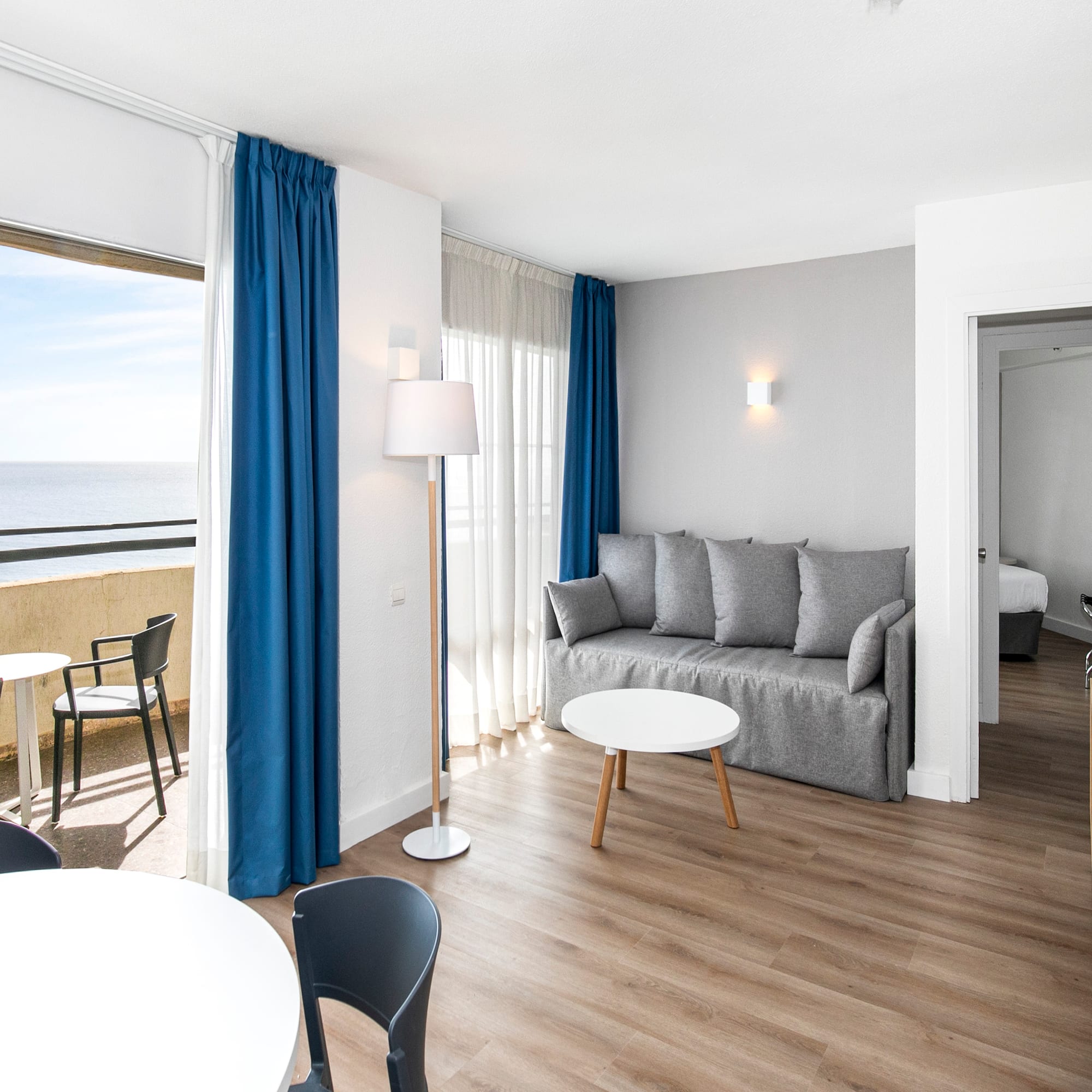 a room with a couch and table and chairs