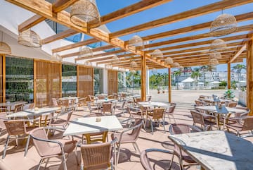 a patio with tables and chairs