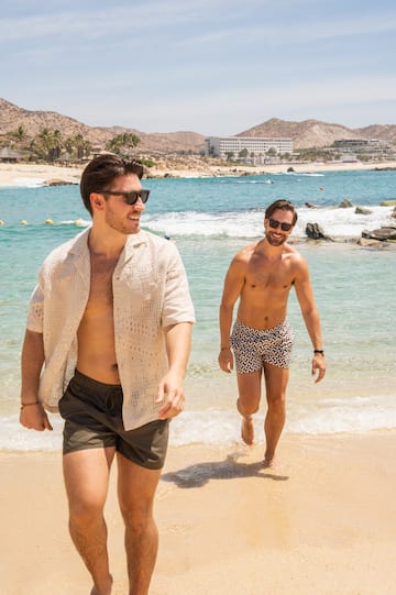two men walking on a beach