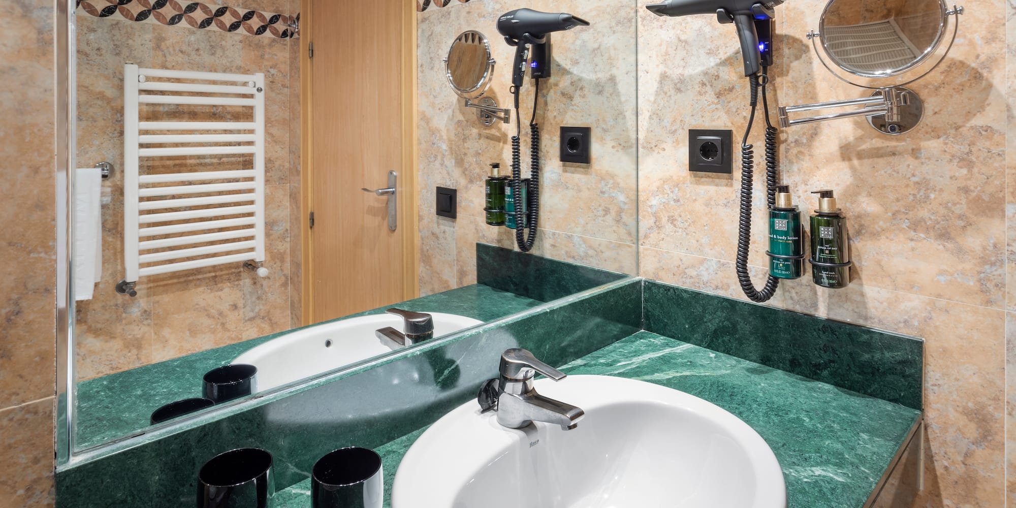 a bathroom with a sink and hair dryer