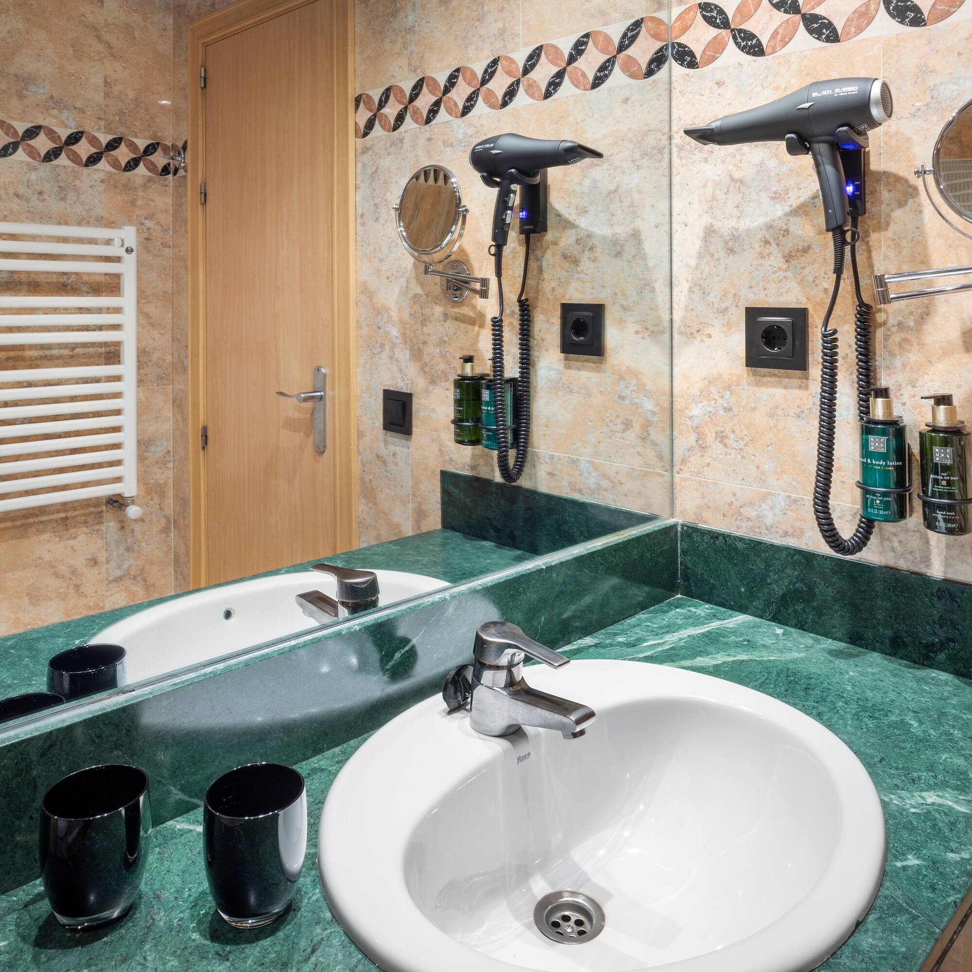 a bathroom with a sink and hair dryer