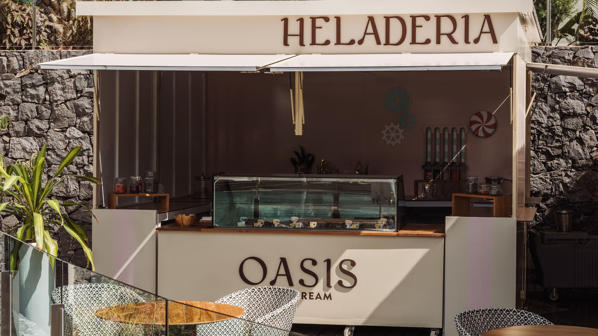 a food stand outside with tables and chairs