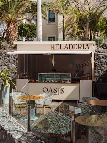 a food stand outside with tables and chairs