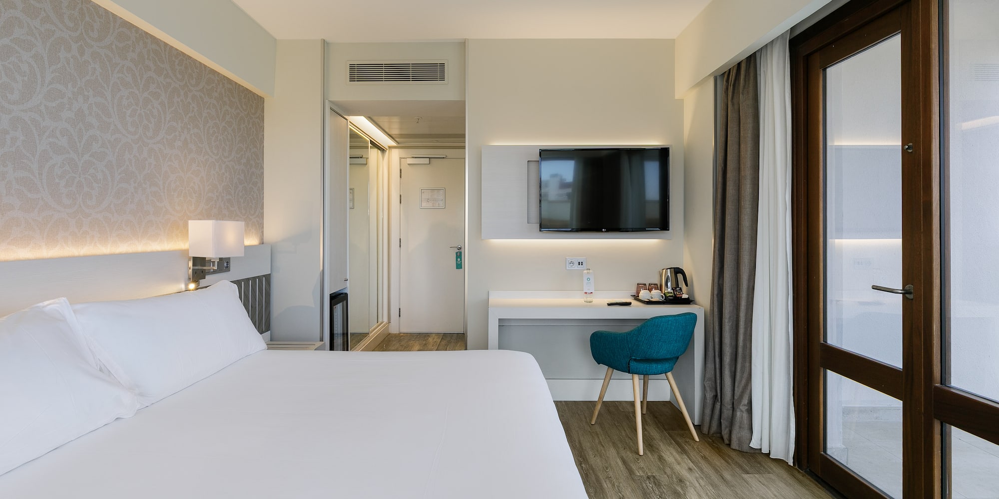 a room with a bed and a desk and a chair