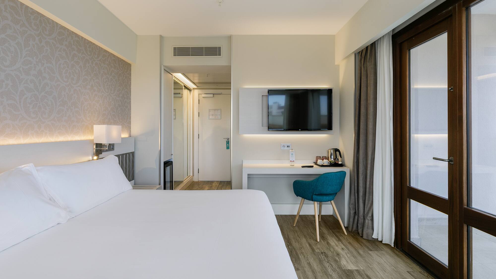 a room with a bed and a desk and a chair