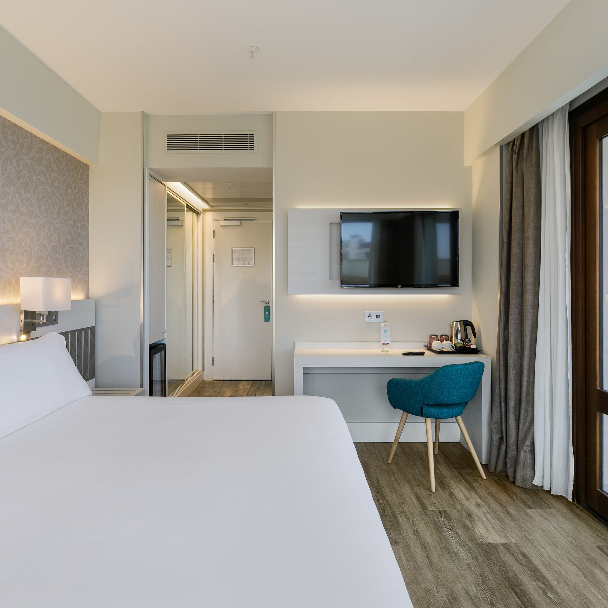 a room with a bed and a desk and a chair