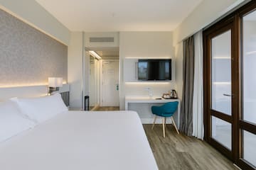 a room with a bed and a desk and a chair