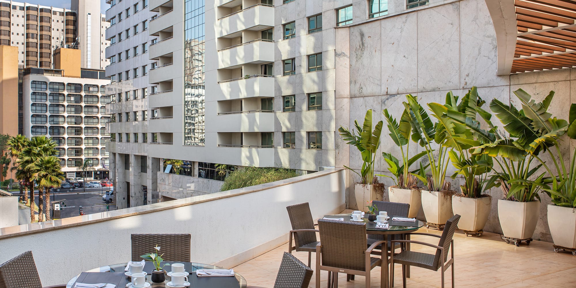 a table and chairs on a balcony with a city view