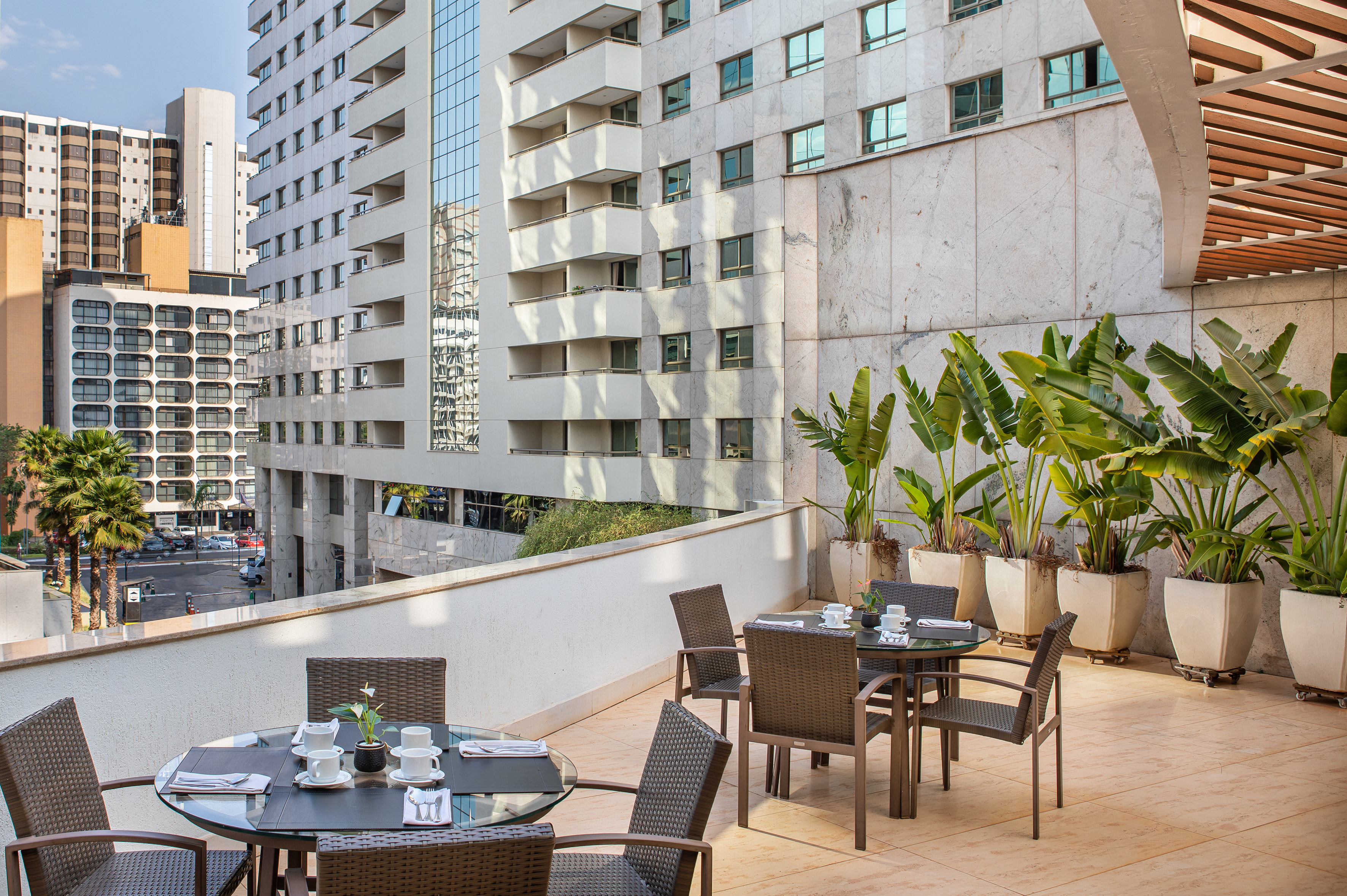 a table and chairs on a balcony with a city view