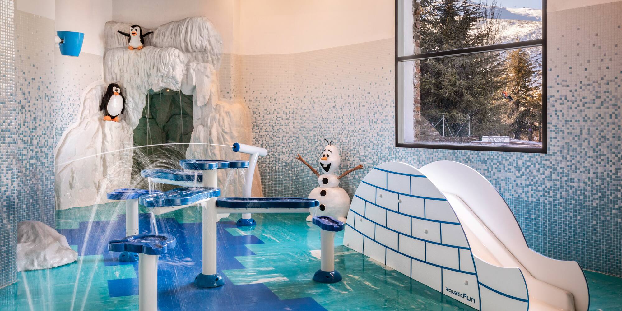 a children's playground with a slide and penguins