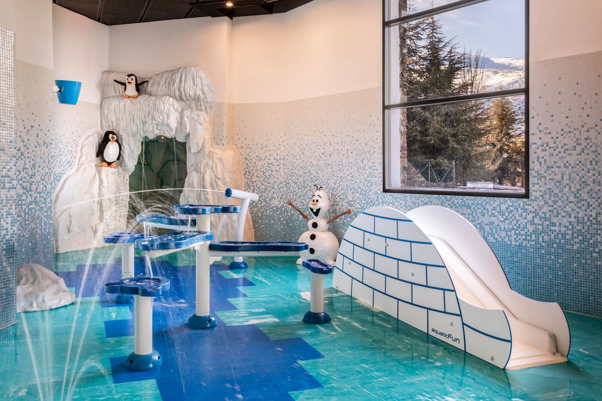 Kids' arctic splash pad with penguins, Olaf, water features, and igloo slide.