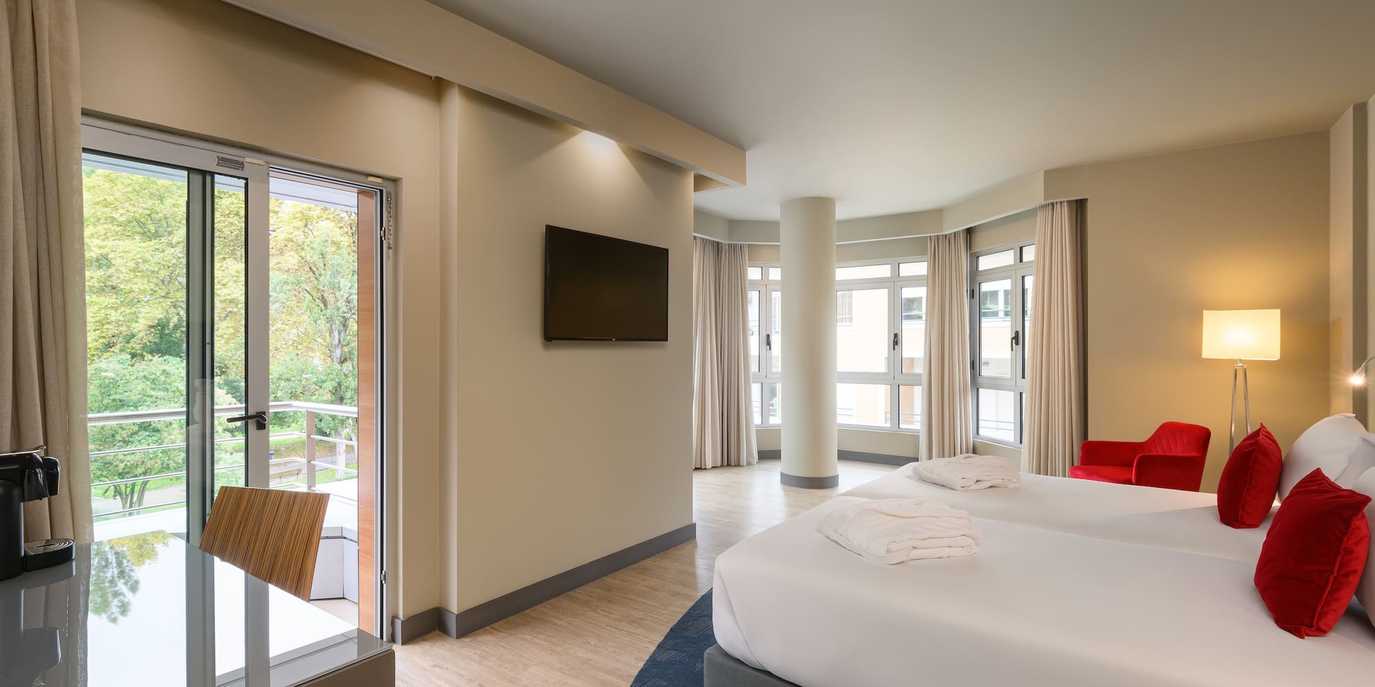 a room with two beds and a television