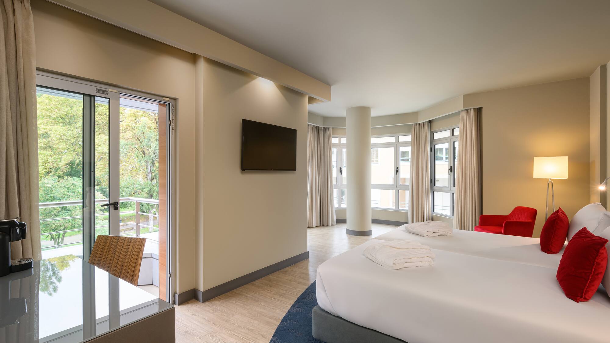 a room with two beds and a television